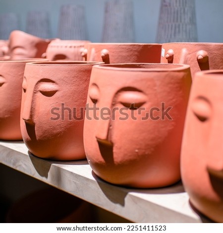 Display of decorative plant vase art shaped like a human head at a gallery in Jakarta Royalty-Free Stock Photo #2251411523