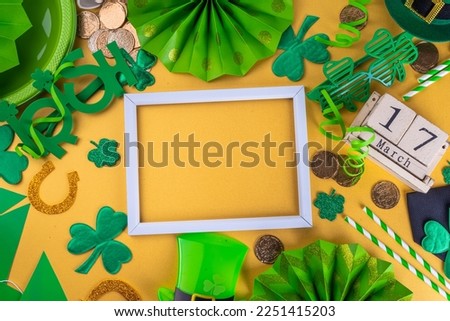 Happy Patrick's Day greeting card, party invitation. Accessories for St Patrick holiday leprechaun hat, glasses, shamrock, gold coins, block calendar March 17 date, ornaments, gold background top view