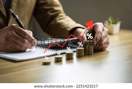 business calculates inflation red arrow with a percentage sign and a pile of coins, concept of higher inflation and more expensive food. Inflation and interest rate hikes Royalty-Free Stock Photo #2251423217