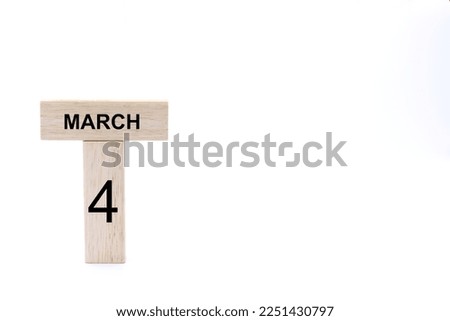 March 4 displayed wooden letter blocks on white background with space for print. Concept for calendar, reminder, date. 
