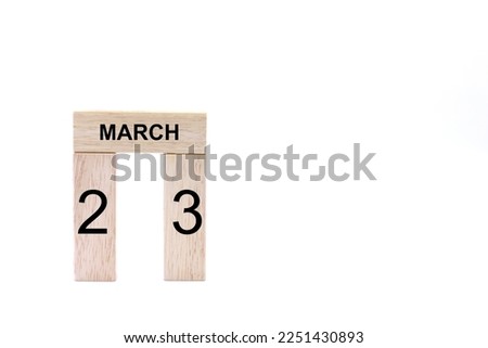 March 23 displayed wooden letter blocks on white background with space for print. Concept for calendar, reminder, date. 