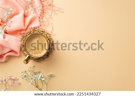 Hello spring concept. Top view photo of cup of coffee on rattan serving mat pink scarf and gypsophila flowers on isolated pastel beige background with copyspace
