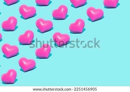Minimal love, Valentine's Day idea. Seamless pattern of vivid pink hearts on pastel blue background.
