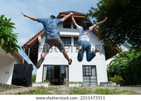Happy couple in front of the New Home On Moving In Day, and start a new life family. Concept of homeowner and relocation Royalty-Free Stock Photo #2251473311