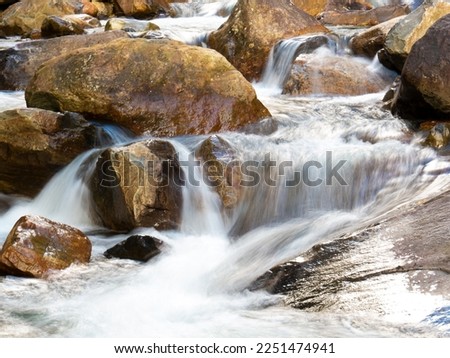 Beautiful waterfall with blurred crystalline waters photographed in long exposure. Selective Focus