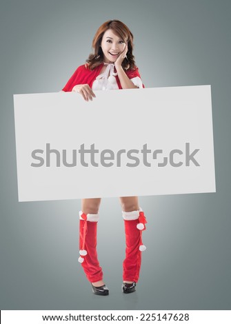 Asian Christmas girl holding a blank board, full length portrait.