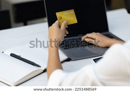 Woman holding credit card and using laptop. Online payment and online  shopping concept.