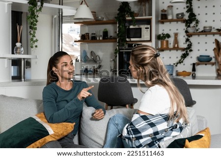 Two young women friends roommates business partners and owners of a small business are arguing at home due to the inappropriate spending of money and increased expenses on household bills. Royalty-Free Stock Photo #2251511463