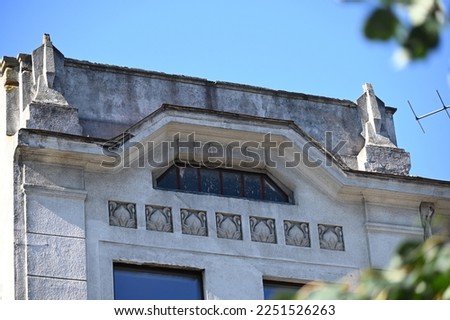 a fragment of the facade of a historical building with an accented parapet in the entrance area Royalty-Free Stock Photo #2251526263