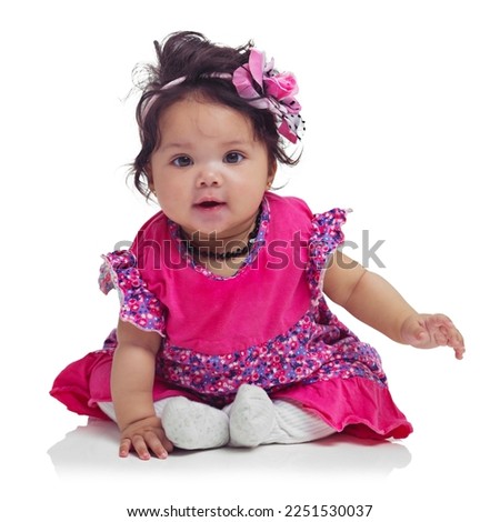 Cute, happy and portrait of a baby girl sitting isolated on a white background in a studio. Girly, playful and innocent, adorable and small child smiling with happiness on a studio background