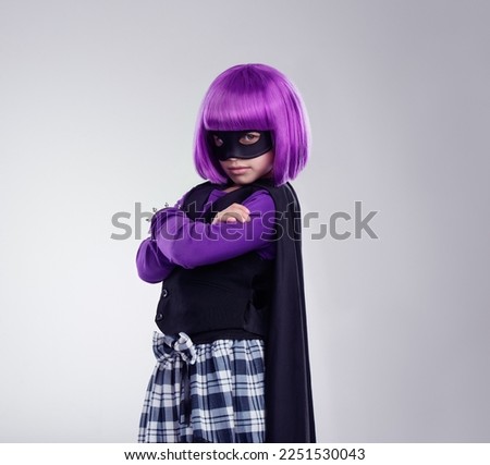 Portrait, girl and mask for costume, hero and confident kid isolated on grey studio background. Face cover, female child and superhero with confidence, dress up and fantasy for cosplay and creative