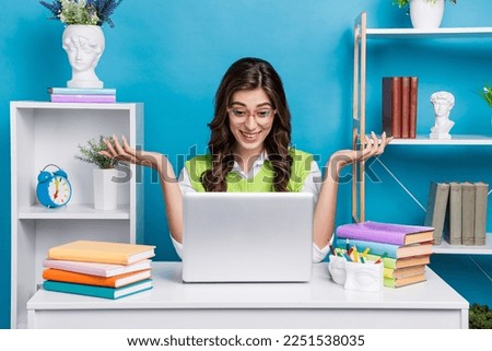 Photo portrait of lovely young lady specs talk excited video meeting workspace wear trendy green garment isolated on blue color background