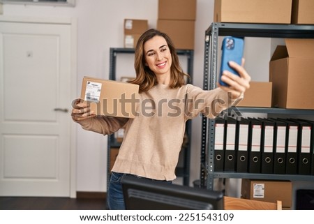 Young woman ecommerce business worker make selfie by the smartphone at office