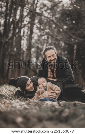 New born fall family photo shoot in forest with happy parents