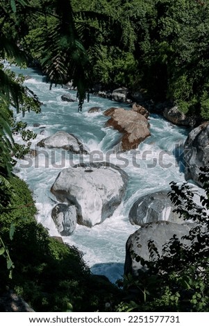 Wild rivers flowing in a deep valley in Chame, Chamje - view from a tea shop. With amazing asian nature, photo from Annapurna circuit trek in Nepal, Himalya mountains. 