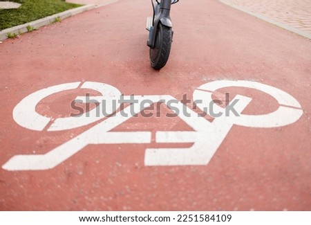 bike lane sign with electric scooter