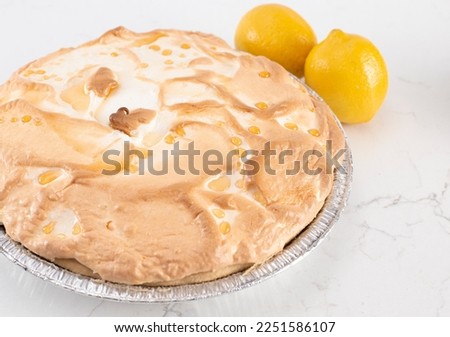 A Whole Fresh Lemon Meringue Pie on a Kitchen Counter