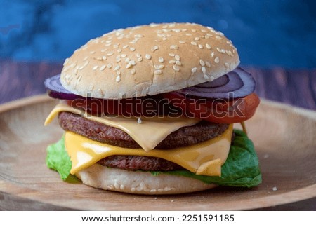 Cheeseburger on a wooden plate
