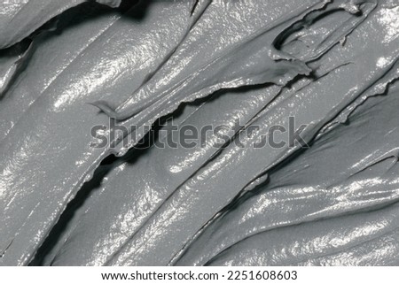 Cosmetic texture clay mask for face and body. Natural spa cosmetics. Dead sea mud gray background. Top view. Space for text Royalty-Free Stock Photo #2251608603