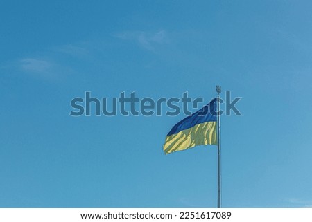 Ukrainian flag against the blue sky close-up