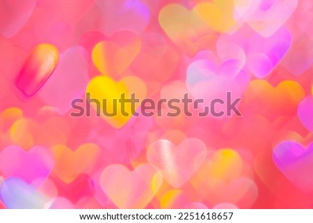 blurred heart shaped holographic bokeh lights background for valentines day