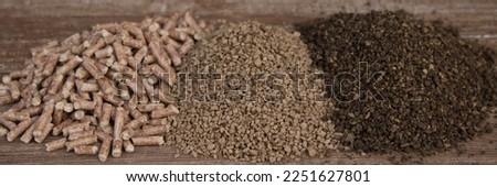 Image of a small pile of pellets, peanuts and olive pomace. Different types of heating fuels for biomass boilers. Horizontal banner 
