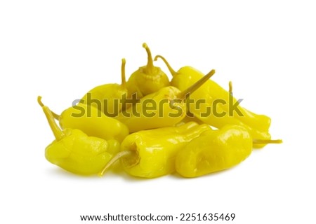 Pile of pickled yellow peppers, pepperoncini or friggitelli isolated on white background. Hot pepper marinated, brined. Traditional Italian and greek cuisine, ingredient for salad, pasta, sauce. Royalty-Free Stock Photo #2251635469