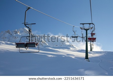 Open seating on a cable car high in the mountains.