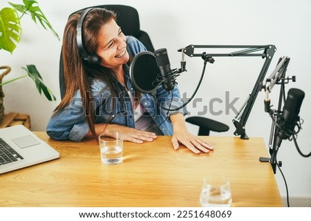 Hosts having podcast session together - Female speaker making an interview during live stream - Main focus on microphone