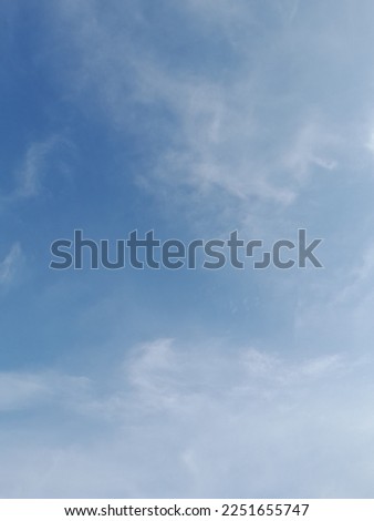 Beautiful white clouds on deep blue sky background. Elegant blue sky picture in daylight. Large bright soft fluffy clouds are cover the entire blue sky.