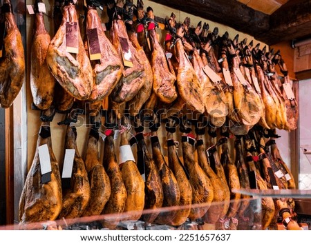 Legs of traditional Spanish jamon ready for sale in grocery Royalty-Free Stock Photo #2251657637