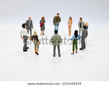 Circle of people. Close up of figures imaging a meeting of business people or a community of friends. Royalty-Free Stock Photo #2251658439