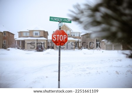 Road stop sign on a snowy road in Ontario Canada