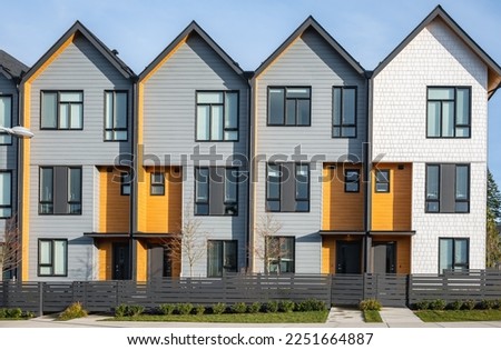 New residential townhouses. Modern apartment buildings in BC Canada. Modern complex of apartment buildings. Concept of real estate development, house for sale and housing market. Copyspace Royalty-Free Stock Photo #2251664887