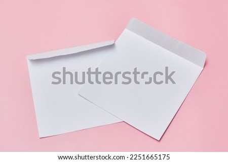 two white envelopes on a pink background with copy space for your text or message, top view stock photo