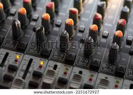 Knobs and switches of audio mixer or recording console. Recording background.  shallow depth of field.