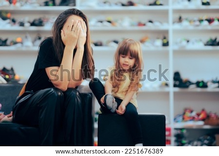 
Stressed Mom Going Shopping for Shoes with her Daughter. Mother feeling upset with the pricey products in a shoe shop 
 Royalty-Free Stock Photo #2251676389