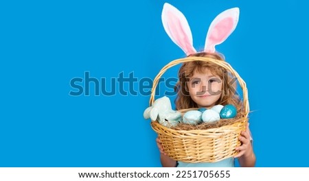 Kid boy with easter basket isolated on blue background. Happy Easter. Easter bunny children. Panoramic web banner frame.