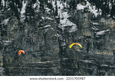 Para-glider in the Bernese alps, Switzerland. Soft focus, selective focus.
