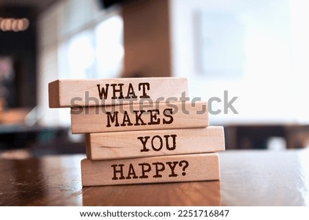 Wooden blocks with words 'What Makes You Happy?'.