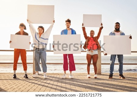 Portrait, poster and diversity with friends together holding signage in protest on the promenade by the sea. Freedom, mockup and billboard with a man and woman friend group holding blank sign boards