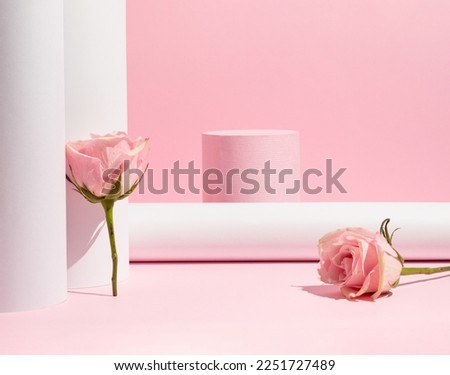 Suitable for Product Display and Business Concept. Modern aesthetic. Product podium and fresh pink rose flowers on pastel pink background. Elegant beauty concept.