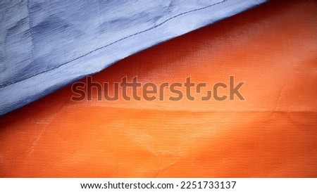 canvas tarpaulin texture, colored orange in the photo on a sunny day