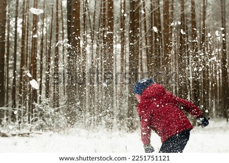 Snow game. Children in the forest.