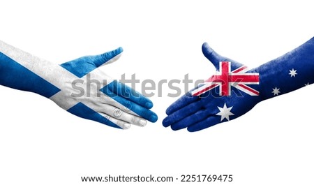 Handshake between Australia and Scotland flags painted on hands, isolated transparent image.