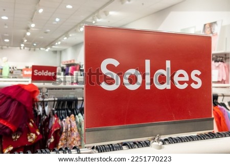 soldes french text means red sale sign on shop shelf in clothing store