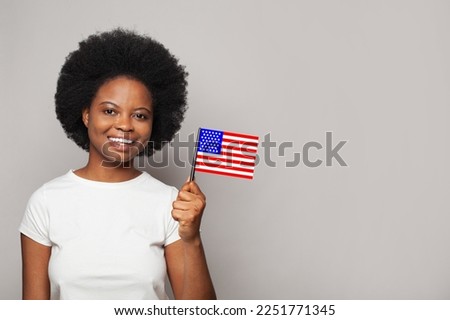American woman holding flag of USA. Education, business, citizenship and patriotism concept