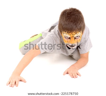 little boy with face painted as a leopard isolated in white
