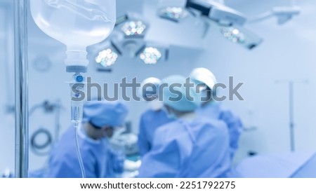 Blue tone picture of syringe pump with blurred background.Intravenous fluid used in the operating room while doctor perform surgery. Medical concept.