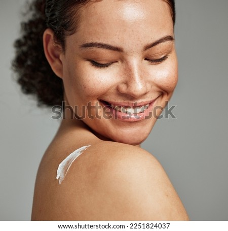 Face, skincare and back of woman with cream in studio isolated on gray background. Cosmetics, beauty dermatology and happy female model with lotion, creme or moisturizer for healthy skin or wellness.